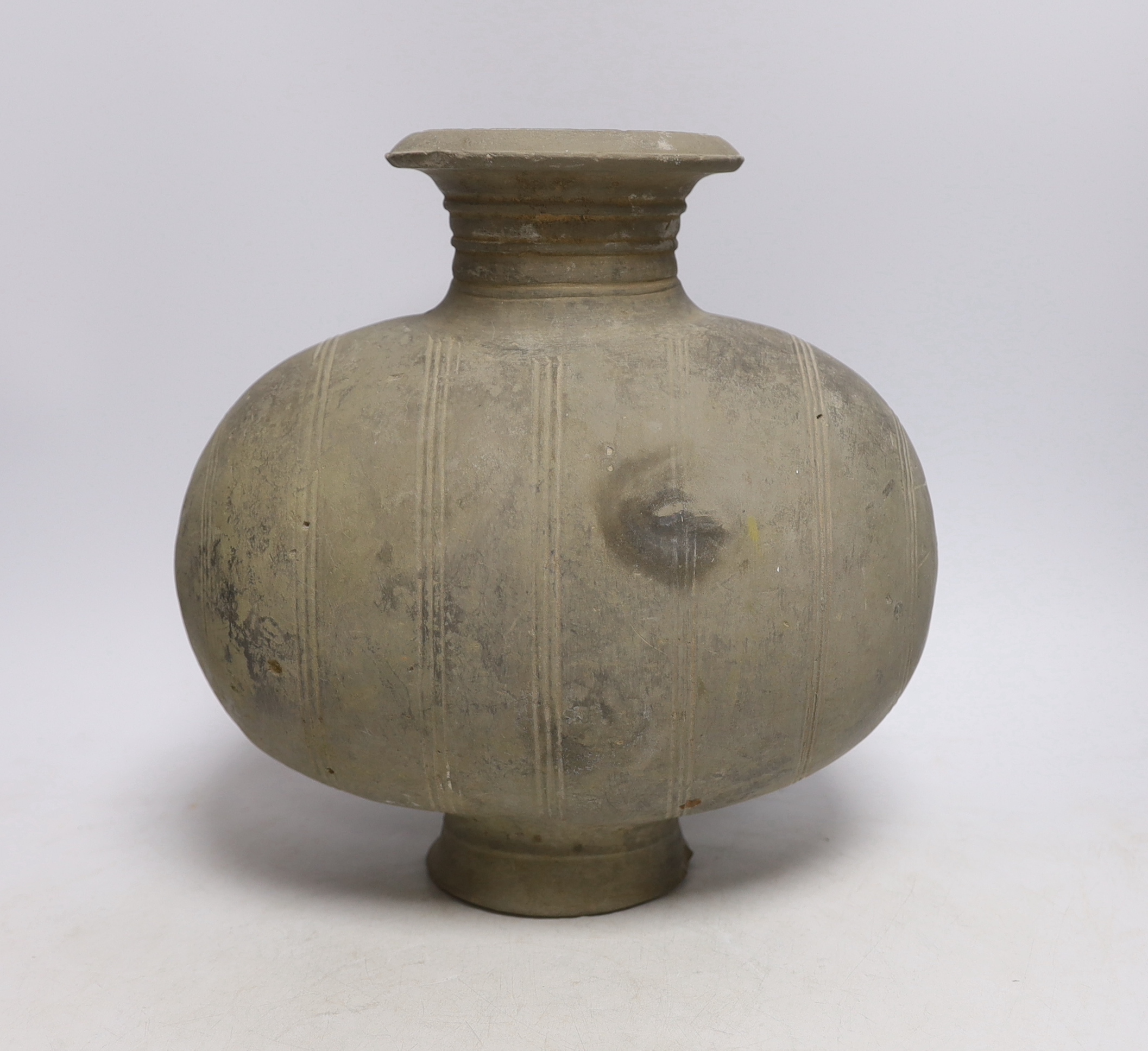 A Chinese grey pottery 'cocoon' jar, Han dynasty, 27cm